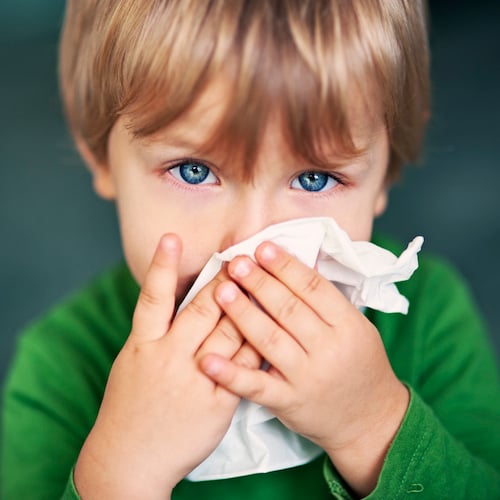 child blowing nose